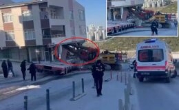 Yokuştan kayan iş makinesi apartmana daldı