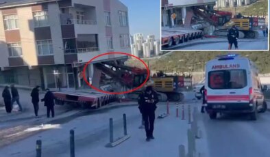 Yokuştan kayan iş makinesi apartmana daldı