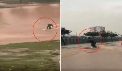 Suyla dolan caddede sörf yaptı