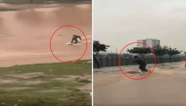 Suyla dolan caddede sörf yaptı